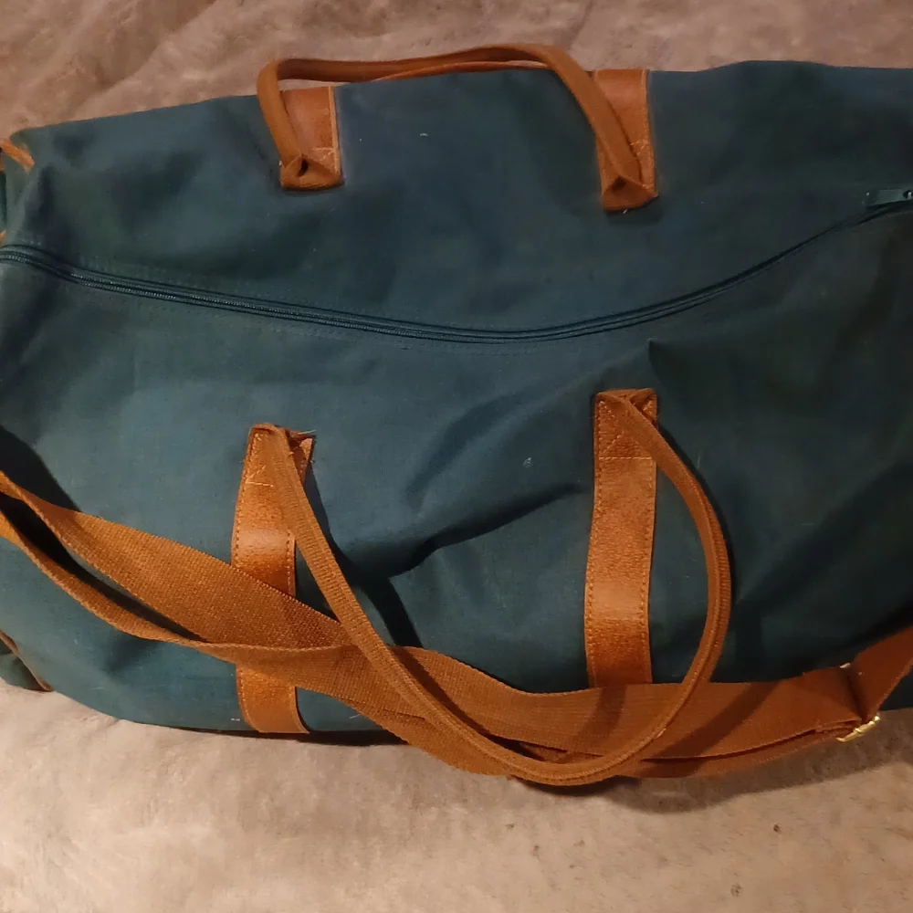 Duffle bag fancy straps are nice accents to this bag